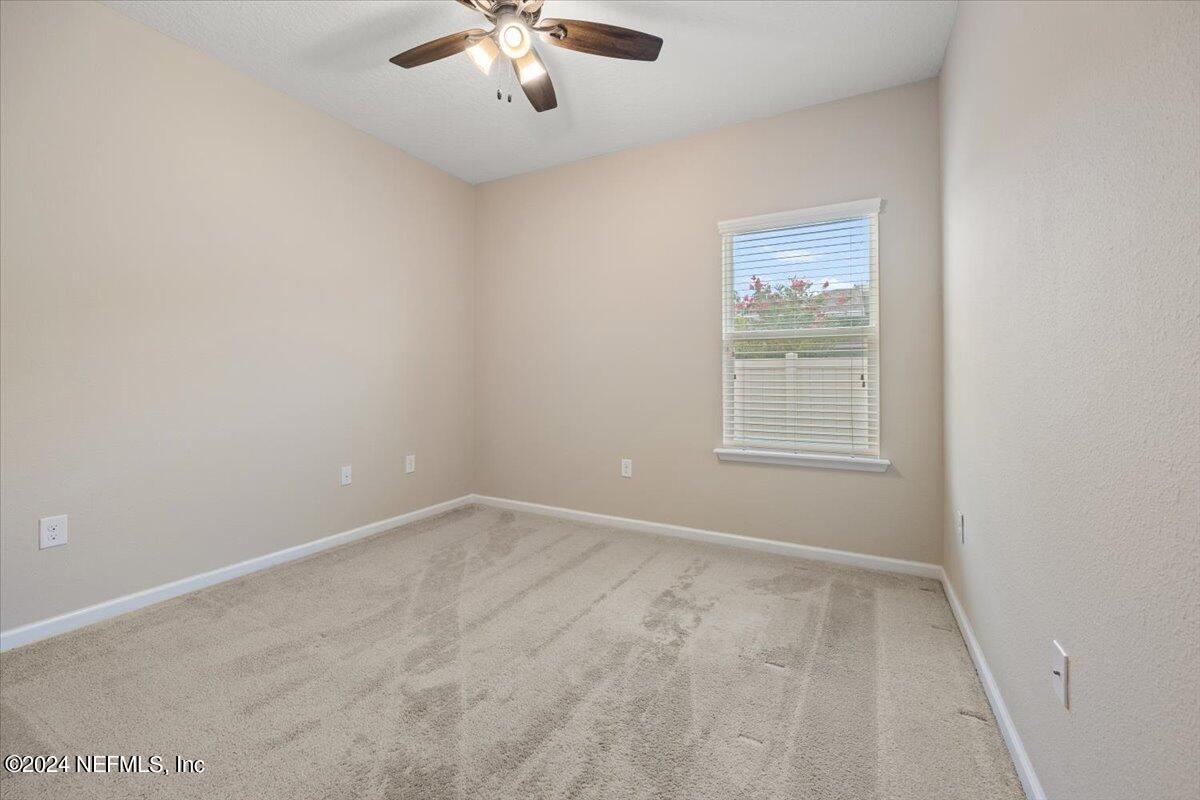 13 Pantano Vista Way St. Augustine, FL 32095 - Photo 21 of 25 an empty room with chandelier fan