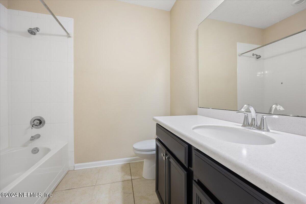 13 Pantano Vista Way St. Augustine, FL 32095 - Photo 24 of 25 a bathroom with a granite countertop sink a toilet and bathtub