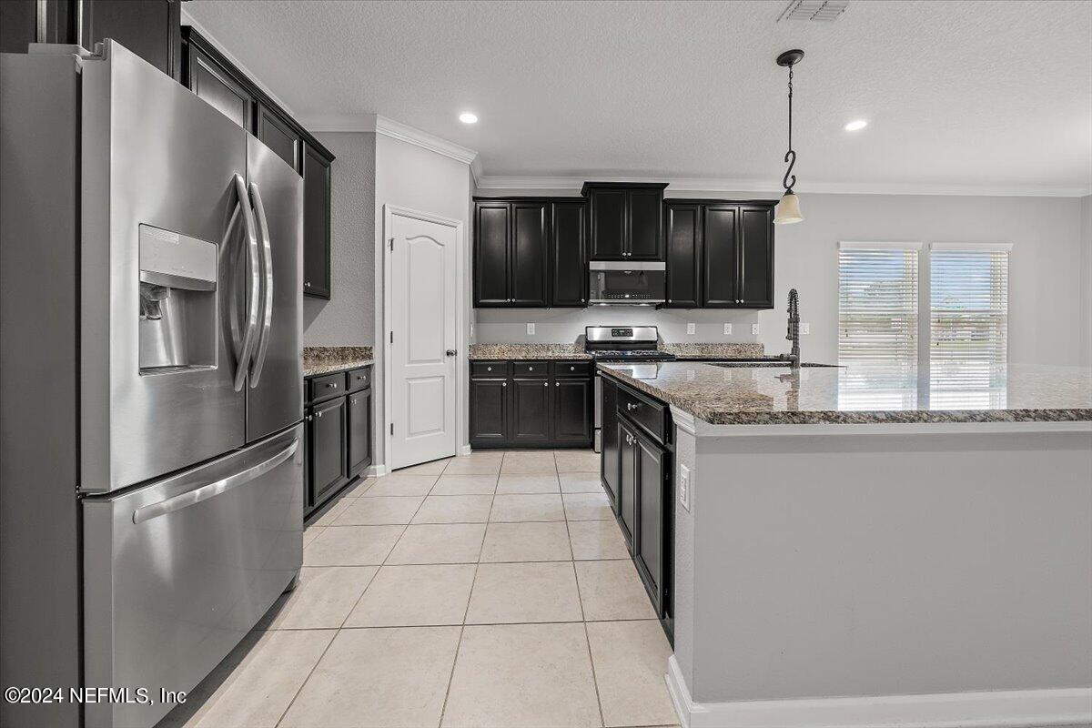 13 Pantano Vista Way St. Augustine, FL 32095 - Photo 8 of 25 a kitchen with stainless steel appliances granite countertop a refrigerator a sink a stove and oven