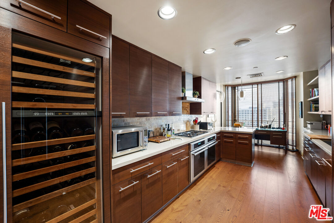 10601 Wilshire Boulevard, Unit 1603 Los Angeles, CA 90024 - Photo 11 of 33 a kitchen with stainless steel appliances granite countertop a stove and a refrigerator