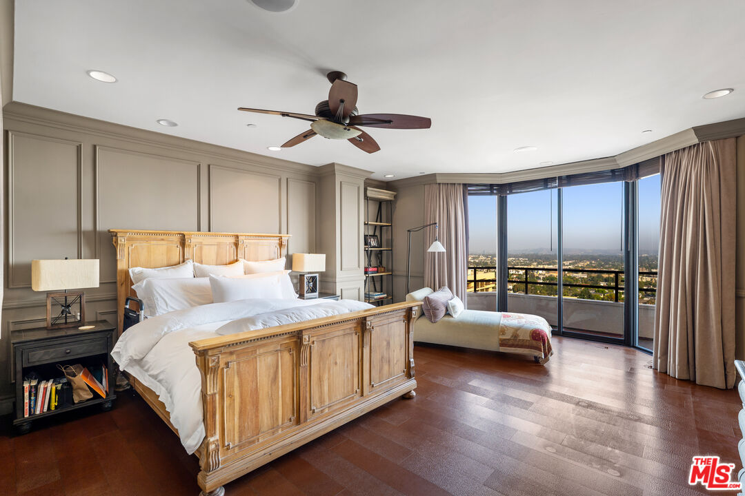 10601 Wilshire Boulevard, Unit 1603 Los Angeles, CA 90024 - Photo 13 of 33 a bedroom with a bed and a chandelier