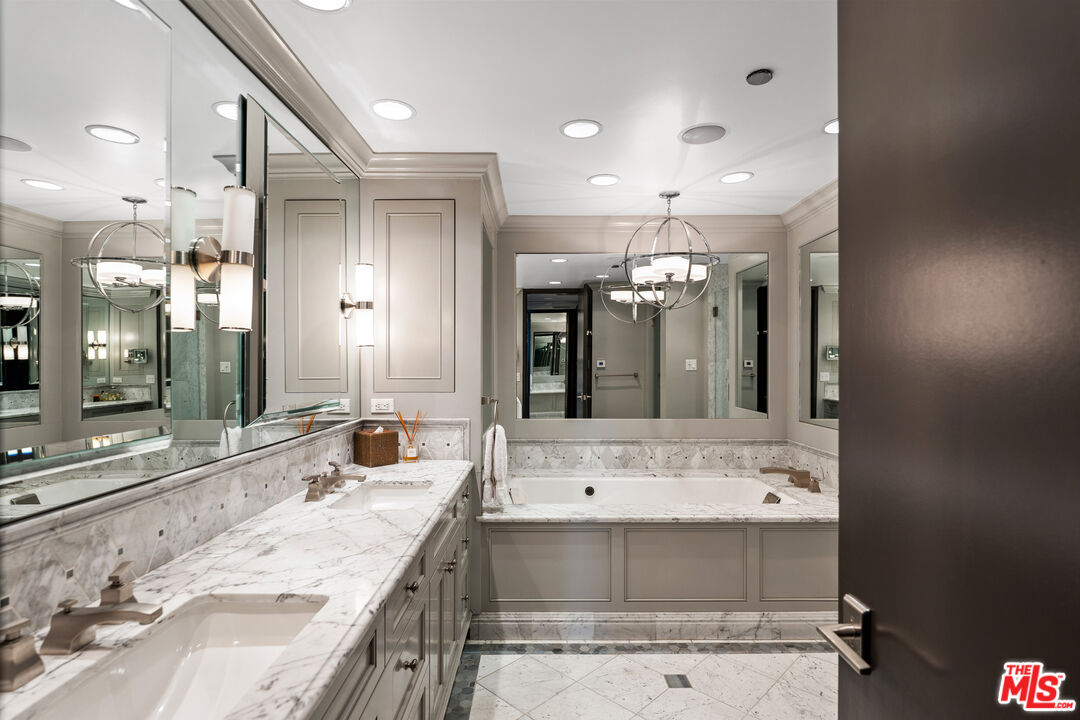10601 Wilshire Boulevard, Unit 1603 Los Angeles, CA 90024 - Photo 15 of 33 a bathroom with a double vanity sink mirror and double