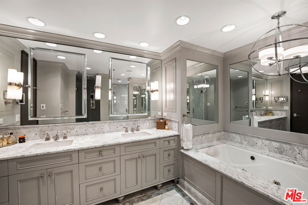 10601 Wilshire Boulevard, Unit 1603 Los Angeles, CA 90024 - Photo 16 of 33 a bathroom with a double vanity sink mirror double and bathtub