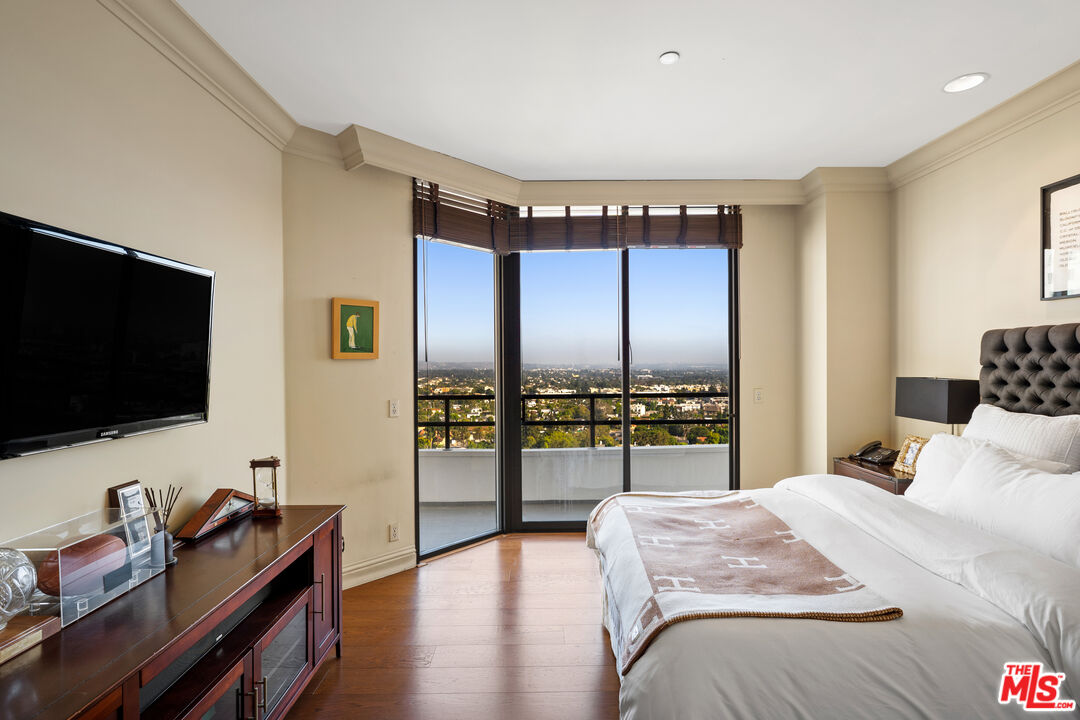 10601 Wilshire Boulevard, Unit 1603 Los Angeles, CA 90024 - Photo 20 of 33 a bedroom with a bed and large flat screen tv