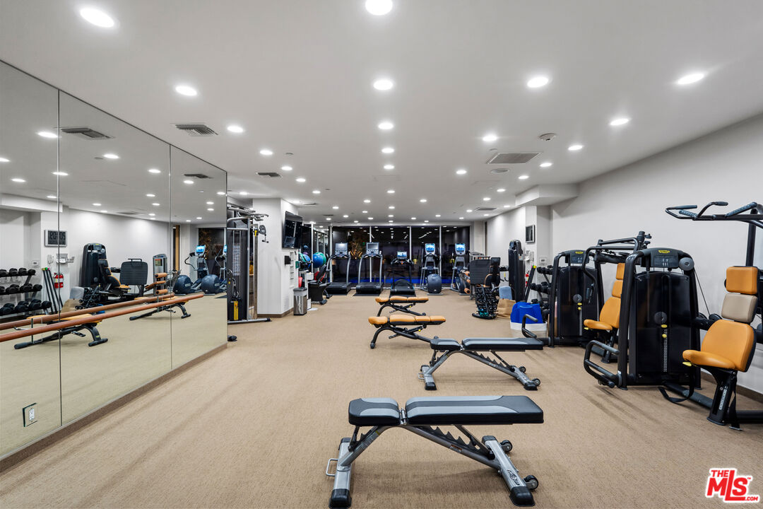 10601 Wilshire Boulevard, Unit 1603 Los Angeles, CA 90024 - Photo 26 of 33 a room with gym equipment and kitchen view
