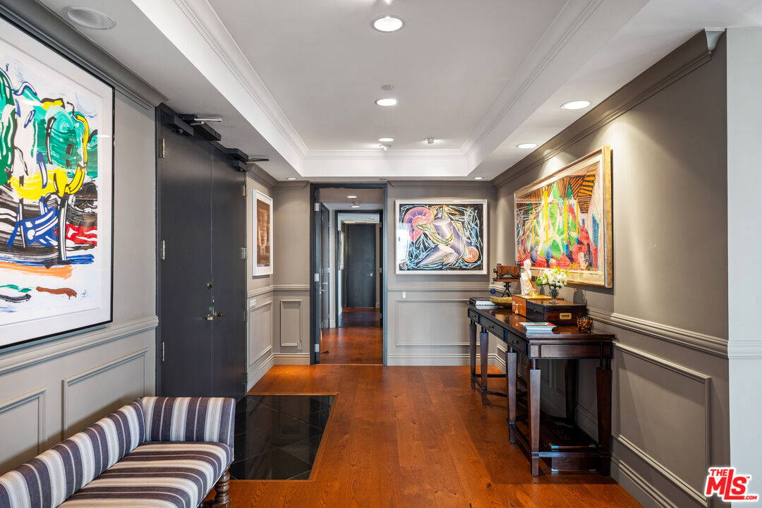 10601 Wilshire Boulevard, Unit 1603 Los Angeles, CA 90024 - Photo 5 of 33 a living room with furniture flat screen tv and wooden floor