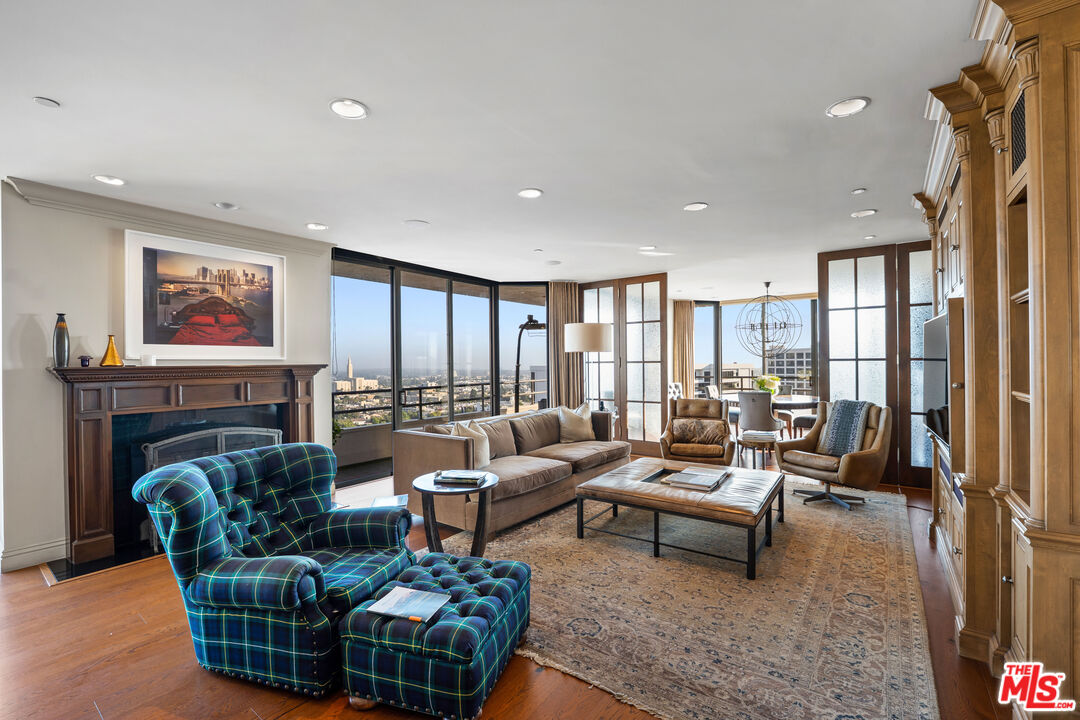 10601 Wilshire Boulevard, Unit 1603 Los Angeles, CA 90024 - Photo 6 of 33 a living room with furniture fireplace and a large window