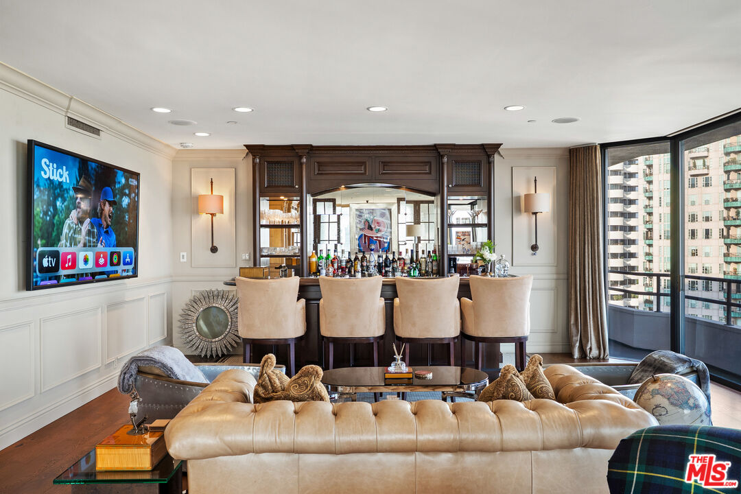 10601 Wilshire Boulevard, Unit 1603 Los Angeles, CA 90024 - Photo 8 of 33 a living room with furniture and large windows