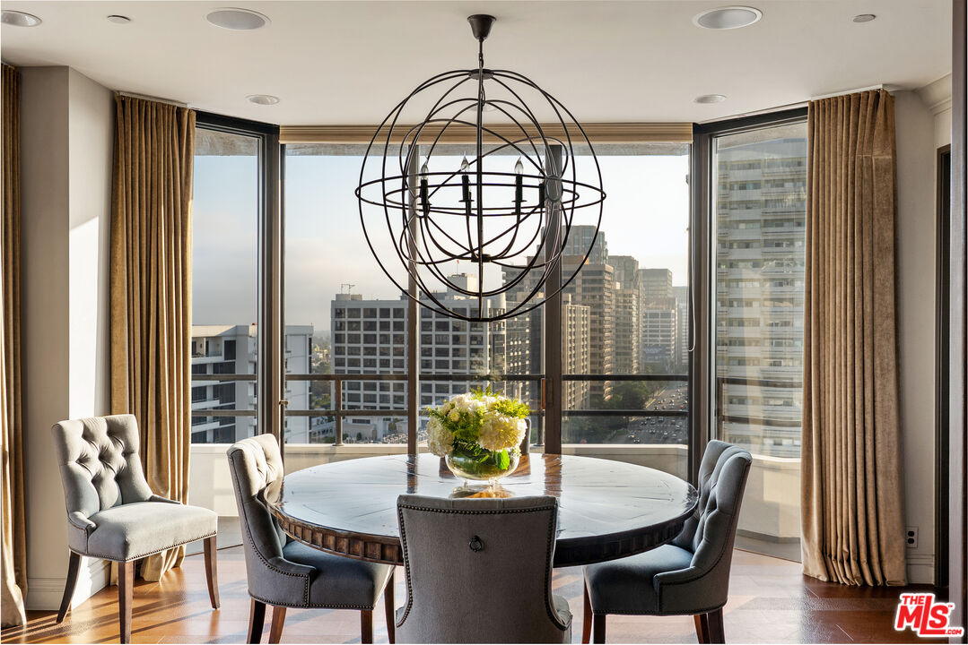 10601 Wilshire Boulevard, Unit 1603 Los Angeles, CA 90024 - Photo 10 of 33 a dining room with furniture a chandelier and wooden floor