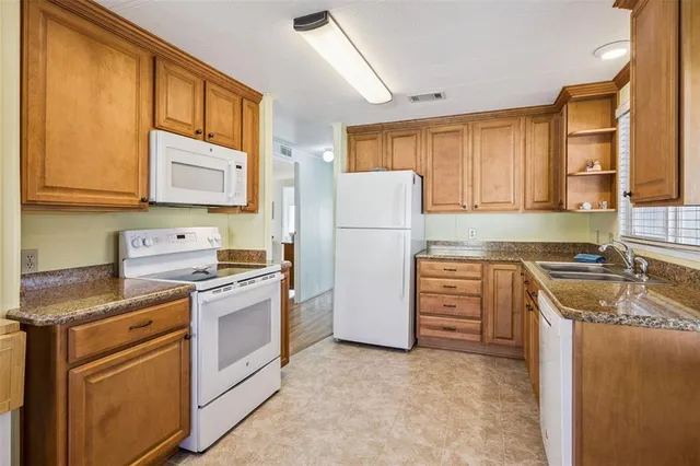 a kitchen with a stove a refrigerator and a sink