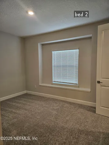 a view of wooden floor and windows in a room