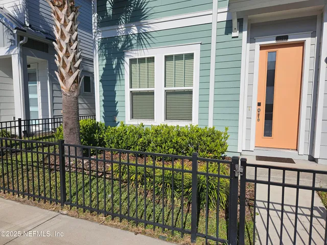 a view of kitchen with wooden floor and electronic appliances
