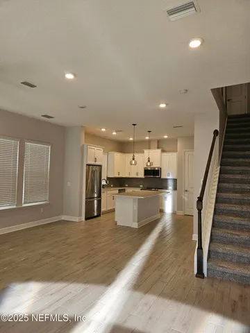 a kitchen with stainless steel appliances granite countertop a stove a sink and a refrigerator