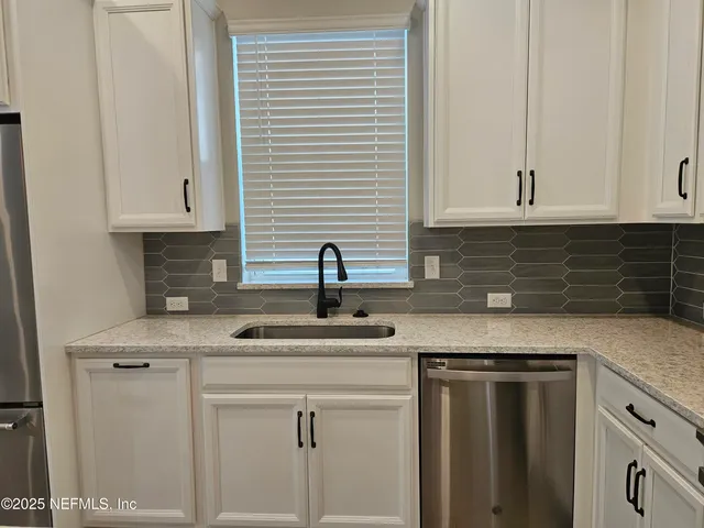 a stove top oven sitting inside of a kitchen