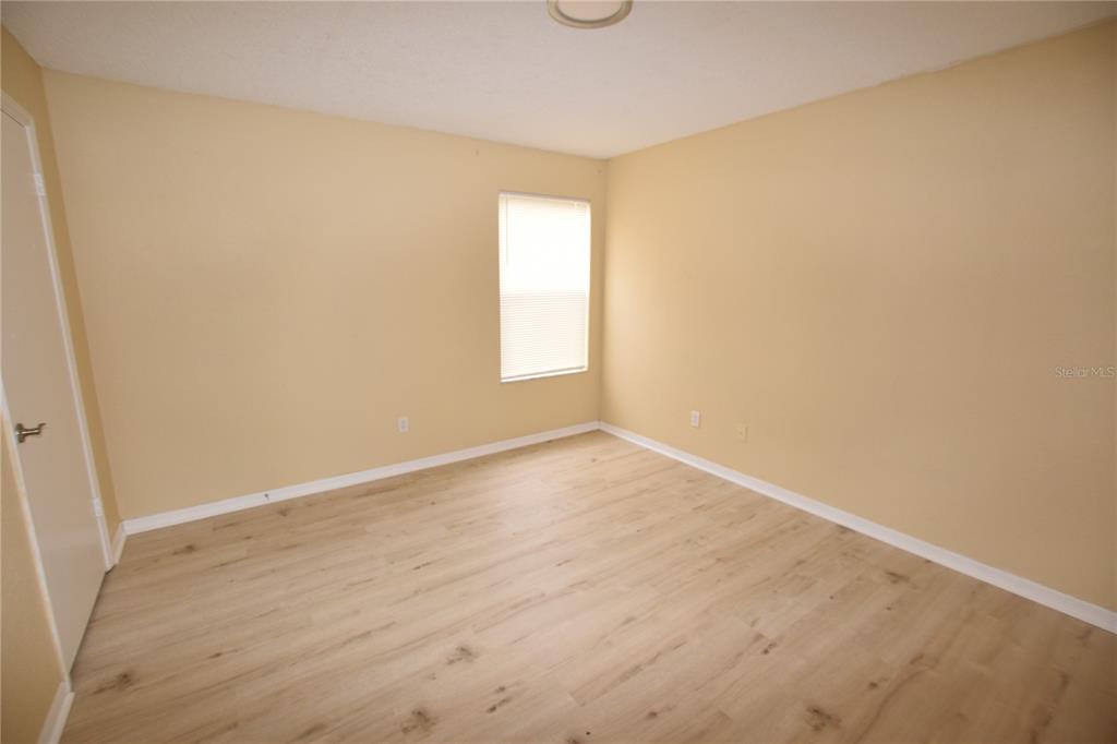 5120 Conroy Road, Unit 511 Orlando, FL 32811 - Photo 13 of 32 an empty room with wooden floor and windows