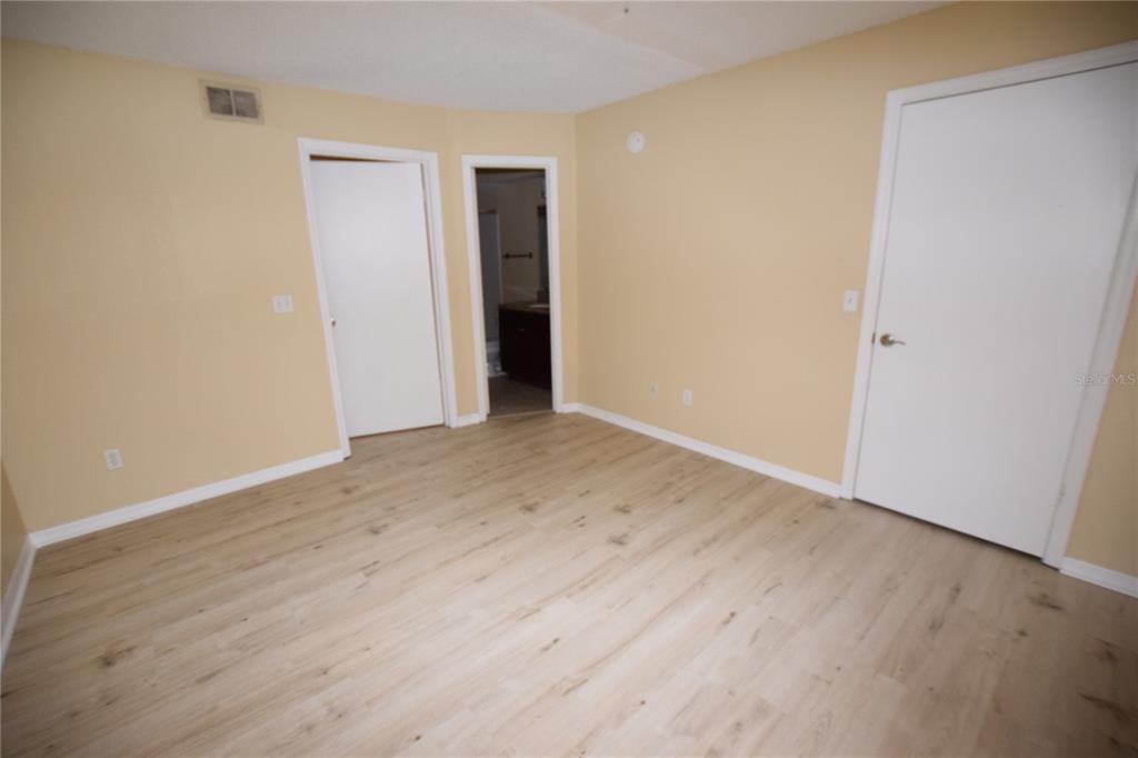 5120 Conroy Road, Unit 511 Orlando, FL 32811 - Photo 15 of 32 a view of an empty room with wooden floor