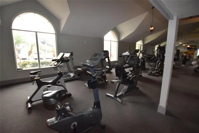 a room with gym equipment and a large window