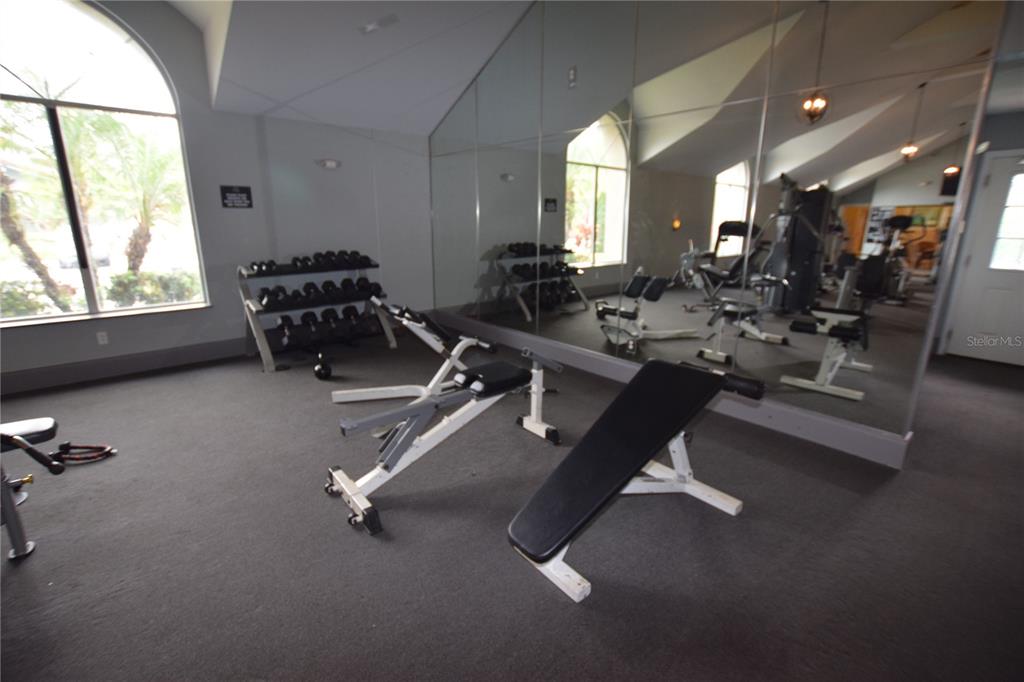 5120 Conroy Road, Unit 511 Orlando, FL 32811 - Photo 26 of 32 a room with gym equipment and a large window