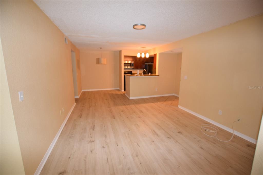 5120 Conroy Road, Unit 511 Orlando, FL 32811 - Photo 3 of 32 a view of a hallway with wooden floor and a bathroom