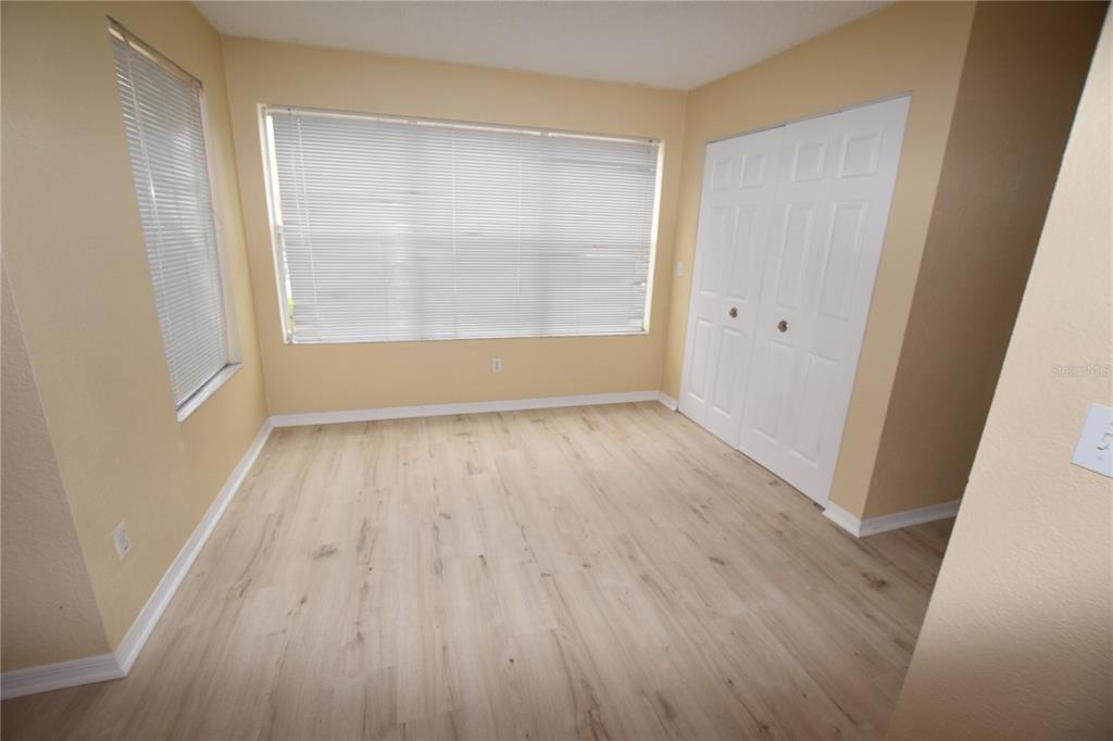 5120 Conroy Road, Unit 511 Orlando, FL 32811 - Photo 7 of 32 an empty room with wooden floor and windows