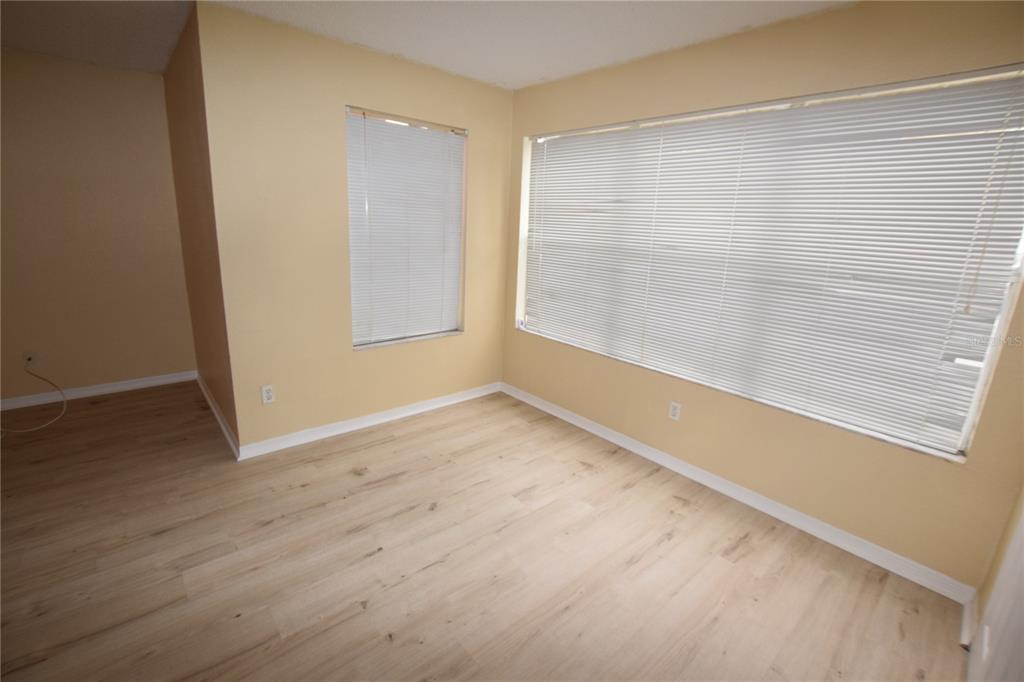 5120 Conroy Road, Unit 511 Orlando, FL 32811 - Photo 8 of 32 a view of an empty room with wooden floor and a window