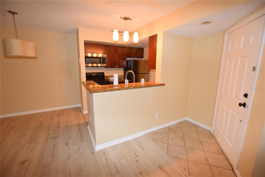 5120 Conroy Road, Unit 511 Orlando, FL 32811 - Photo 10 of 32 a view of a kitchen from the hallway