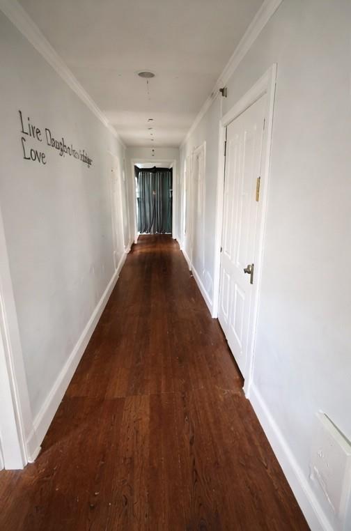 405 West Elm Street Olney, TX 76374 - Photo 3 of 13 a view of a hallway with wooden floor
