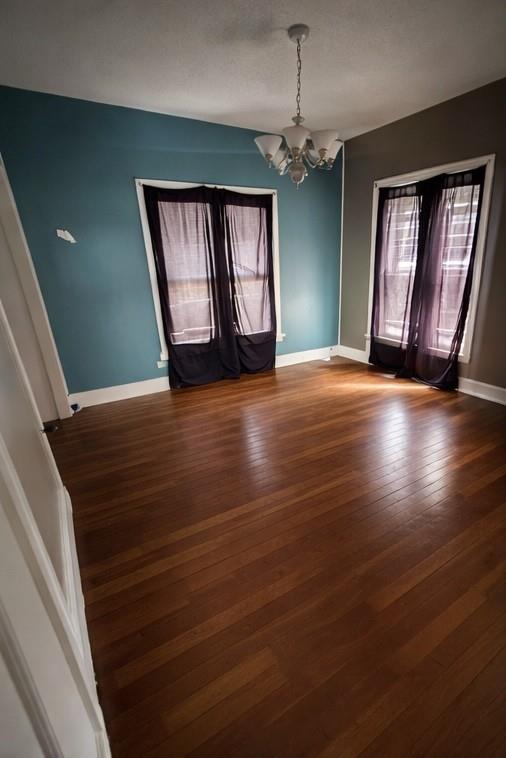 405 West Elm Street Olney, TX 76374 - Photo 4 of 13 a view of an empty room with wooden floor and a window