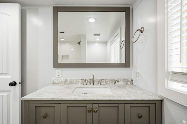 2029 West Crescent Row Mapleton, UT 84664 - Photo 23 of 28 Vanity with a stone countertop, undermount sink, and brushed nickel faucet