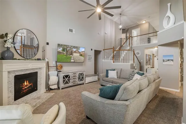 a living room with furniture a fireplace and a chandelier