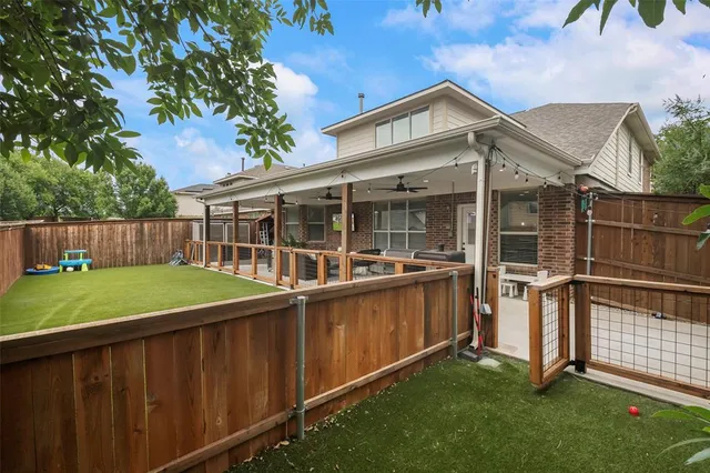 a view of a house with a backyard and a patio