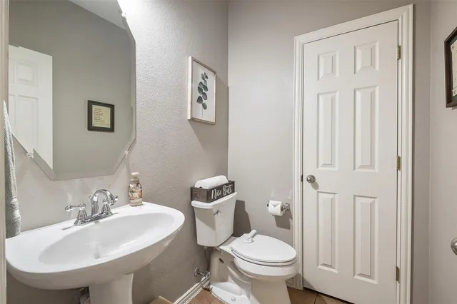 a bathroom with a sink toilet and a mirror