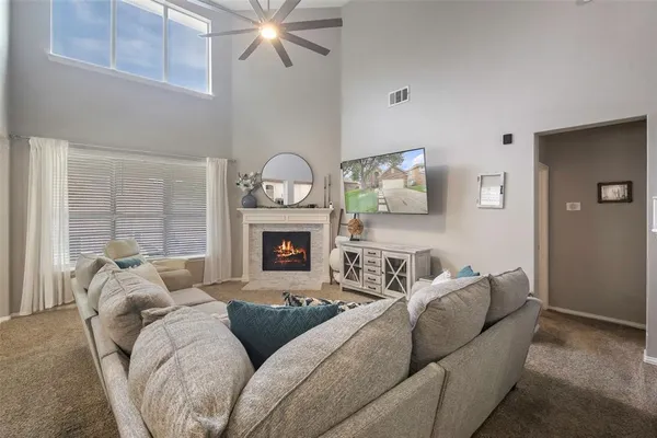 a living room with furniture and a fireplace