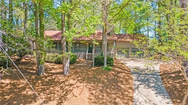 a backyard of a house with table and chairs