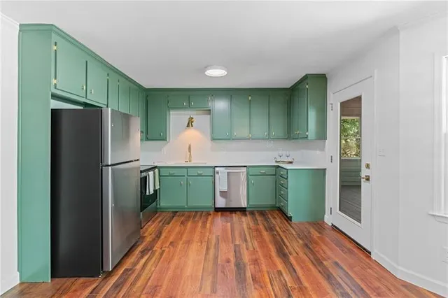 a kitchen with a refrigerator and a sink