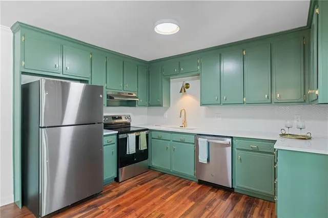a kitchen with a refrigerator and a sink