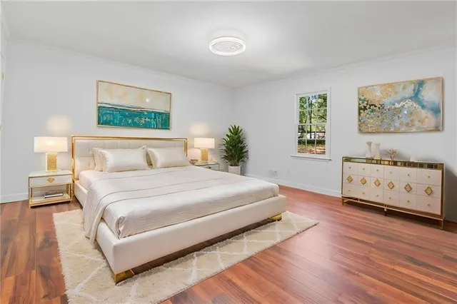 a bedroom with a bed and a night stand