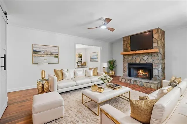 a living room with furniture and a fireplace