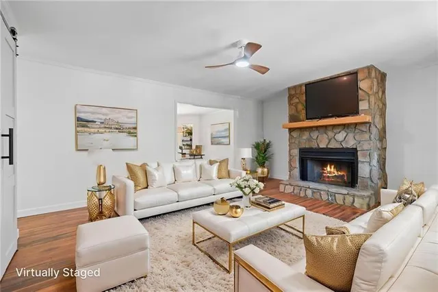 a living room with furniture and a fireplace