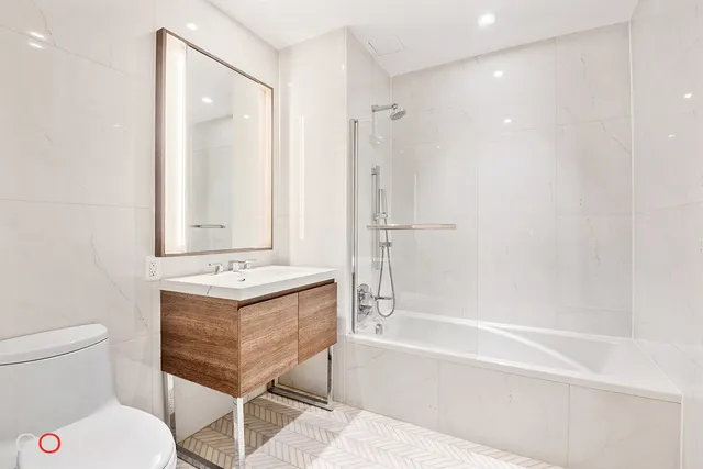 a bathroom with a sink toilet tub and shower