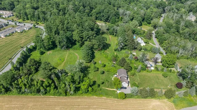 a backyard of a house with a yard and fountain