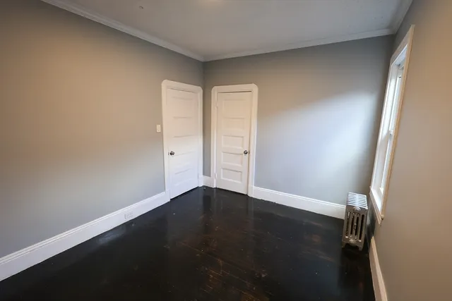 an empty room with wooden floor