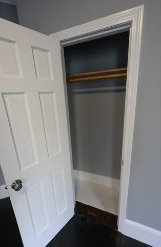 an empty room with wooden floor and closet