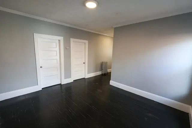 a view of an empty room and wooden floor