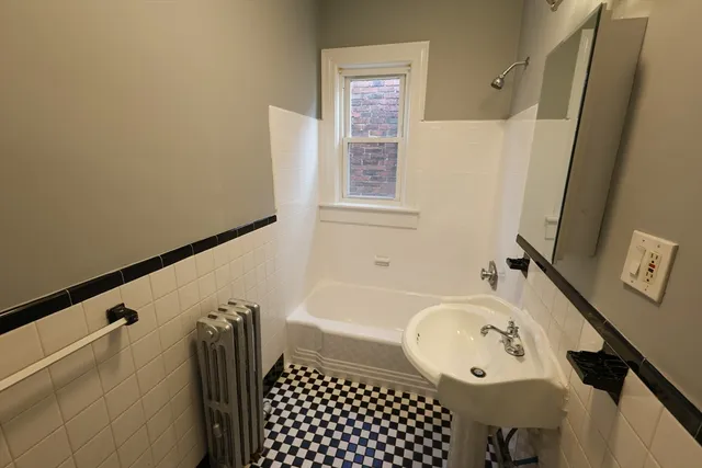a bathroom with a bathtub and shower