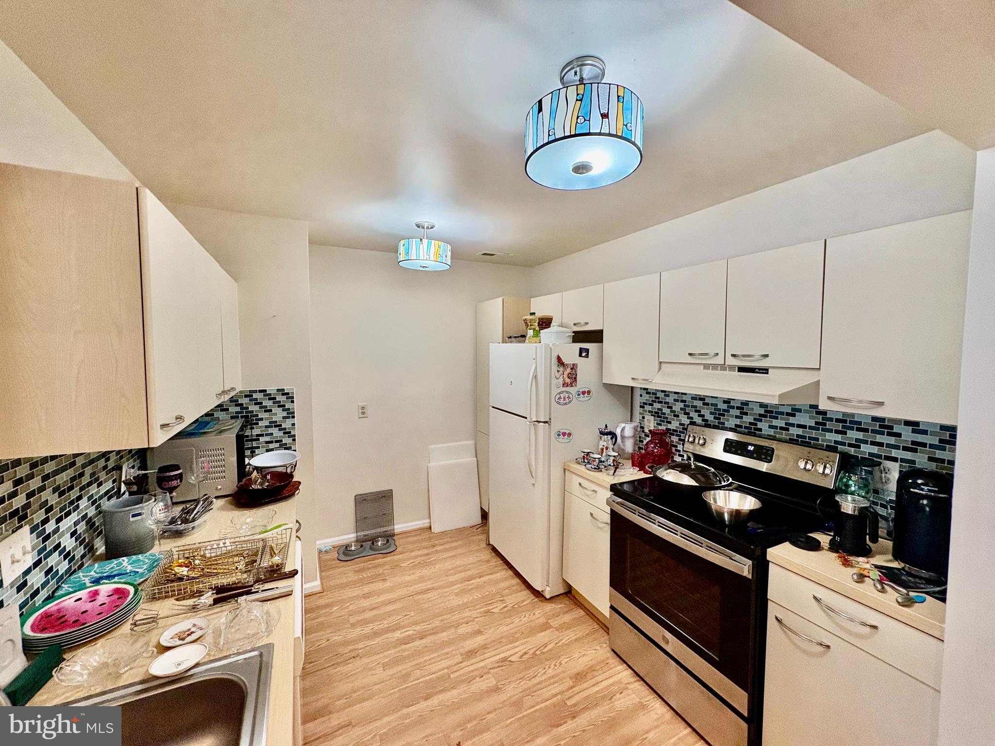 550 Central Avenue Linwood, NJ 08221 - Photo 6 of 13 a kitchen with stainless steel appliances granite countertop a stove and a wooden floors