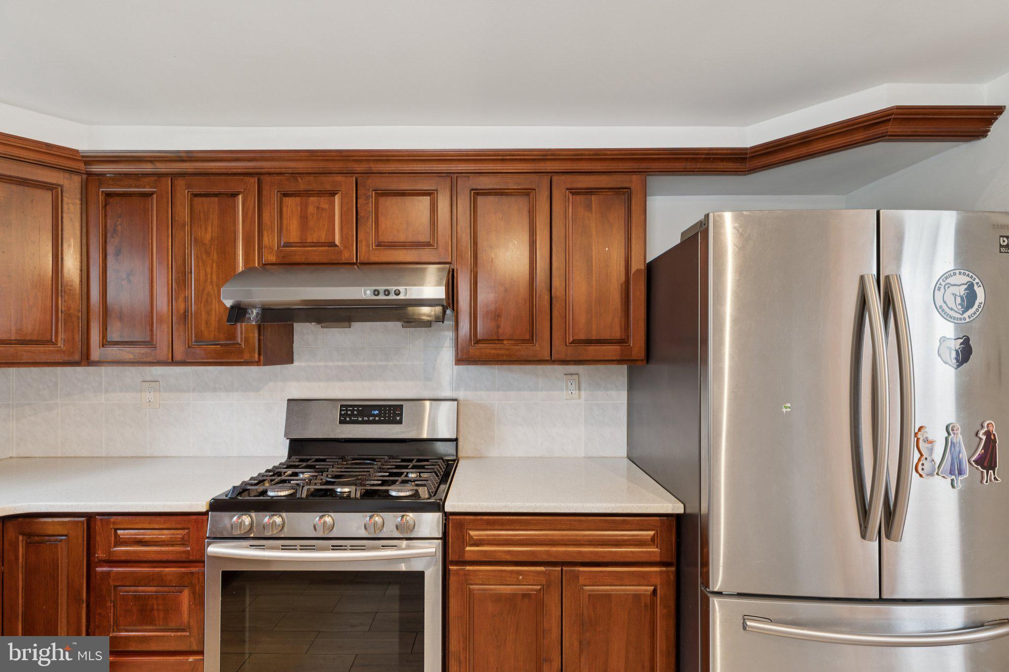 730 Millwood Road Philadelphia, PA 19115 - Photo 18 of 52 a kitchen with a stove and a refrigerator