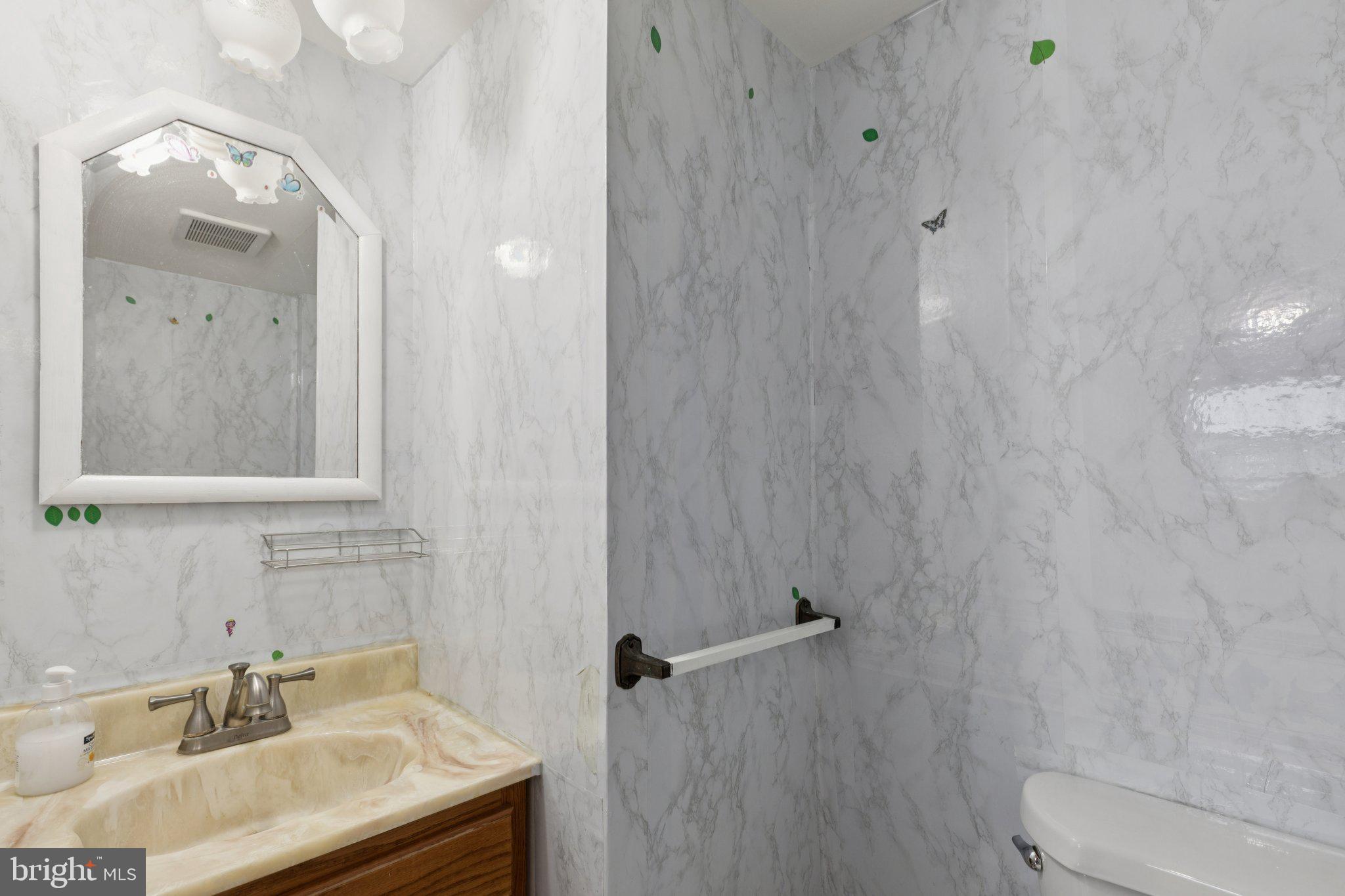 730 Millwood Road Philadelphia, PA 19115 - Photo 23 of 52 a bathroom with a sink vanity mirror and toilet