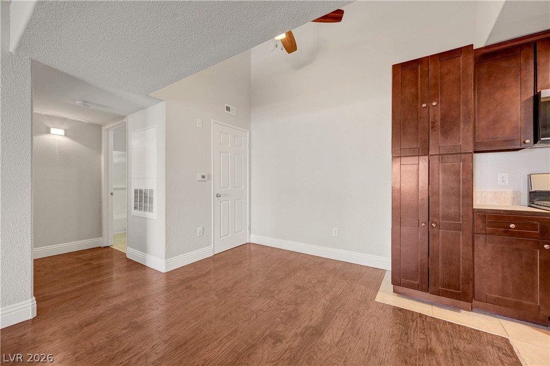 7885 West Flamingo Road, Unit 1050 Las Vegas, NV 89147 - Photo 10 of 62 Rich hardwood flooring enhances this comfortable living space with a vaulted ceiling.