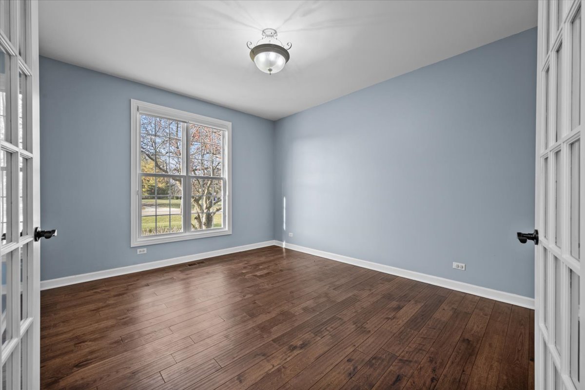 7N095 Ridge Line Road St. Charles, IL 60175 - Photo 8 of 40 an empty room with wooden floor and windows